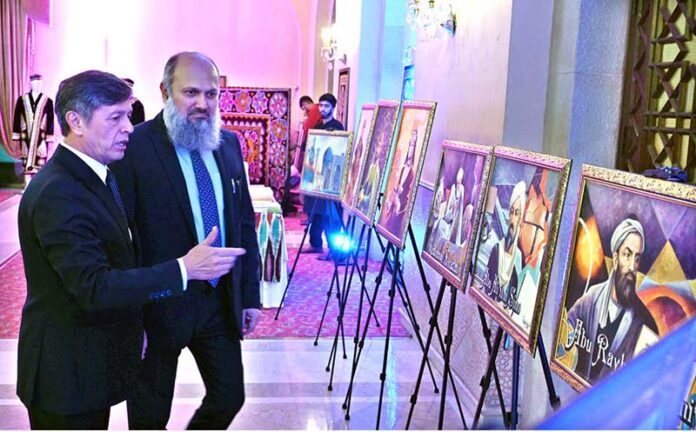 Federal Minister for Commerce Jam Kamal Khan along with Oybek Usmanov, Ambassador of Uzbekistan to Pakistan viewing photos during a ceremony celebrating the 33rd Anniversary of the Independence Day of the Republic of Uzbekistan