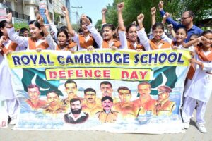 Students are participating in the rally in connection with Pakistan Defense Day at Latifabad