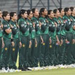 Players of Pakistan Women's cricket team stand in respect during the National Anthem before the 1st T20 match against South Africa Women at Multan Cricket Stadium