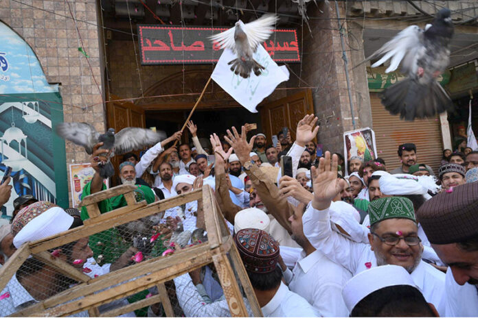 Pir Syed Inayat Ali Shah & devotees release pigeons on the occasion of Eid Milad-un-Nabi (SAWW) celebrations outside at Milad house