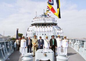 President Asif Ali Zardari in a group photo with senior military officials and crew of Pakistan Navy Ship Hunain during its induction ceremony