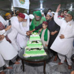 Pir Syed Inayat Ali Shah along with followers cutting cake on the occasion of Eid Milad-un-Nabi (SAWW) celebrations at Milad House
