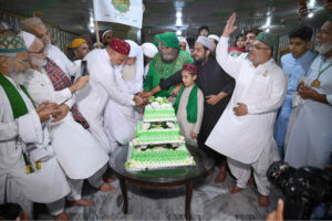 Pir Syed Inayat Ali Shah along with followers cutting cake on the occasion of Eid Milad-un-Nabi (SAWW) celebrations at Milad House