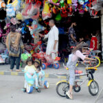Children test-riding bicycles while selecting the best ones to purchase near the Blue Dome stop