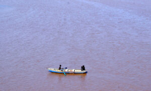 A boatman ferries passengers across the River Ravi following his daily routine in the provincial capital.