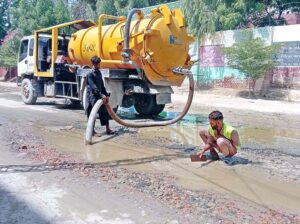 Municipal Corporation staff engaged in drainage of rain water standing on Government Girls High School Main Road.