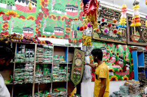 A shopkeeper is arranging decorative items as Muslims celebrate Eid Milad un Nabi, the birthday of the last prophet Hazrat Muhammad (PBUH) on the 12th day of Rabi’ al-awwal.