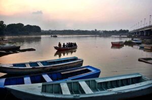 People are enjoying riding on boats in the River Ravi during the evening time in the Provincial Capital.