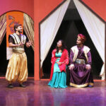 Artists performing on stage in a theater play for children ‘Ali aur Dragon’ organized by Arts Council of Pakistan