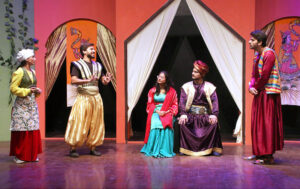 Artists performing on stage in a theater play for children ‘Ali aur Dragon’ organized by Arts Council of Pakistan