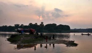 People are enjoying riding on boats in the River Ravi during the evening time in the Provincial Capital.
