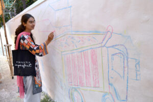 Art students from various colleges and universities painting a mural on the Radio Pakistan building to attract passers-by and students