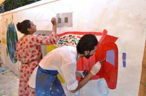 Art students from various colleges and universities painting a mural on the Radio Pakistan building to attract passers-by and students