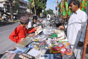 Children are buying decorative items from roadside stalls to decorate their homes on Milad-ul-Nabi (PBUH),as Muslims celebrate Eid Milad un Nabi,on the birthday of the Islamic prophet Hazrat Muhammad (PBUH) on the 12th day of Rabi' al-awwal.