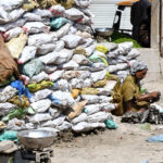 A vendor displaying traditional vegetable Beeh to attract the customers at vegetable market