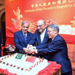 President Asif Ali Zardari, Prime Minister Muhammad Shehbaz Sharif and Ambassador of People's Republic of China to Pakistan Jiang Zaidong cutting cake of 75th anniversary of People's Republic of China