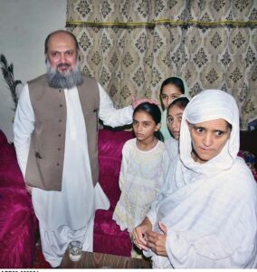 Federal Minister for Commerce Jam Kamal Khan presenting a bouquet to the family of Martyred Soldier Haroon William in tribute during a Defence Day visit to their home.