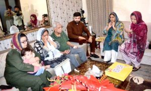 Minister of State for IT and Telecommunication Ms. Shaza Fatima Khawaja offering Fateha with the family of Captain Muhammad Ali Qureshi Shaheed.