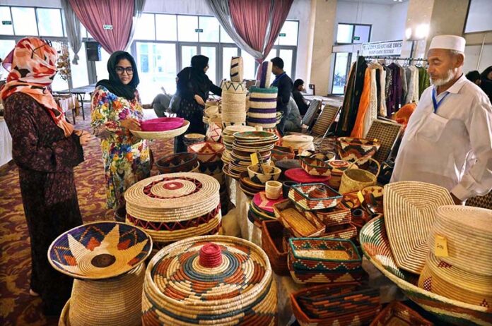Visitors taking keen interest in different handmade items displayed by artisans during two day "Daachi Arts & Craft Exhibition" at Pak China Friendship Centre in the Federal Capital