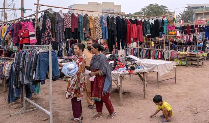 People busy in selecting and purchasing second-hand warm clothes at Kuri Road neighbourhood as winter season approaching