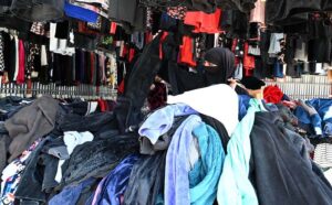 A woman selecting to stock up on second-hand warm clothes and other stuff from vendor at the weekly Bazaar as the capital city prepares for the onset of winter.