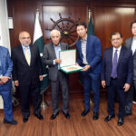 Federal Minister for Maritime Affairs Qaiser Ahmed Sheikh is presenting souvenir to representative of Malaysian Company