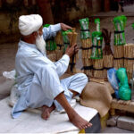 An elder vendor is displaying traditional toothbrush (Miswak) at Zahoor Ali Road