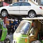 A traffic warden uses a lifter to remove an illegally parked car, clearing obstacles to ensure a smooth traffic flow and prevent disruptions for commuters