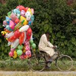A vendor carrying colorful balloons on his bicycle for selling at Lehtrar Road neighbourhood in the Federal Capital