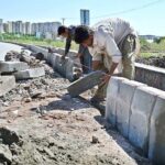 Labourers busy in fixing cemented blocks along Club Road in Federal Capital