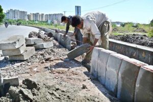 Labourers busy in fixing cemented blocks along Club Road in Federal Capital