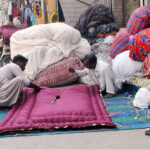 Workers are busy stitching Quilts at their workplace as demand increases in the winter season