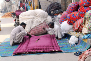Workers are busy stitching Quilts at their workplace as demand increases in the winter season