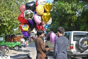 A customer purchasing balloon from a street vendor at Jinnah Super Market in the Federal Capital