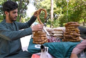 A vendor selling walnuts at his roadside stall, getting ready for the day's business in the Federal Capital.