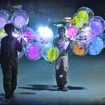 Street vendors displaying led light balloons to attract the customers at Latifabad