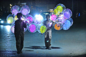 Street vendors displaying led light balloons to attract the customers at Latifabad