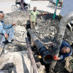 Sui Southern Gas company workers welding big plastic pipeline to connect a new gas line for heavy pressure at Norani Basti area