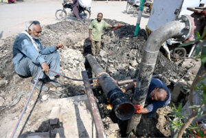 Sui Southern Gas company workers welding big plastic pipeline to connect a new gas line for heavy pressure at Norani Basti area