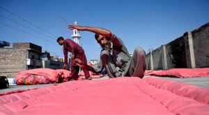 Workers are busy stitching Quilts at their workplace as demand increases in the winter season