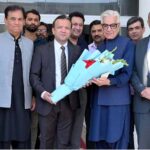 The newly elected President of the Chamber of Commerce Ikramul Haque is presenting a bouquet to Defense Minister Khawaja Muhammad Asif during his visit to SCCI
