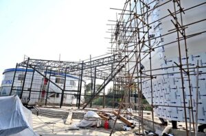 Labourers busy in construction work of CDA Business Facilitation Centre at G-7 sector.