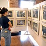 Foreigner women keenly viewing photos during an exhibition at PNCA on the occasion of Kashmir Black Day