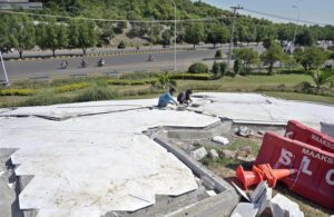 CDA workers painting the poles of the highest flag for preparation ahead of the 23rd Shanghai Cooperation Organization (SCO) summit at Zero Point in the Federal Capital.