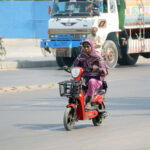 A woman riding a scooter at National Stadium Road