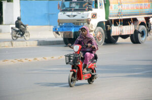 A woman riding a scooter at National Stadium Road