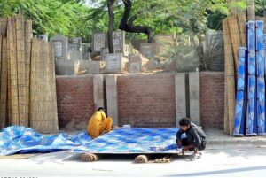 Workers are busy preparing traditional curtain (Chik) at their roadside setup