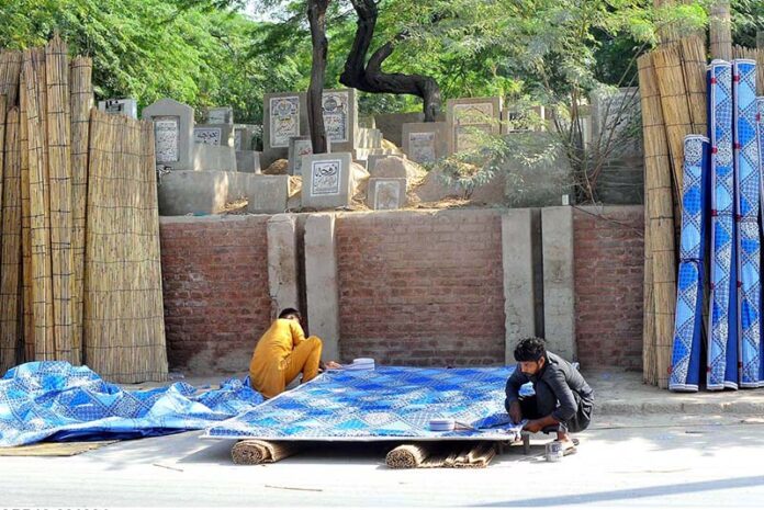 Workers are busy preparing traditional curtain (Chik) at their roadside setup