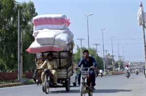 An over loaded Motor Riksha on the busy Jail Road.