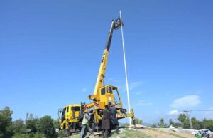 CDA workers painting the poles of the highest flag for preparation ahead of the 23rd Shanghai Cooperation Organization (SCO) summit at Zero Point in the Federal Capital.